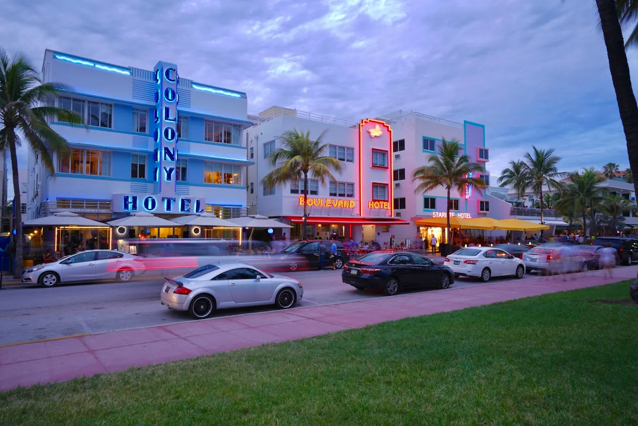 Art Deco beachfront hotels at dusk in Miami South Beach with neon signage