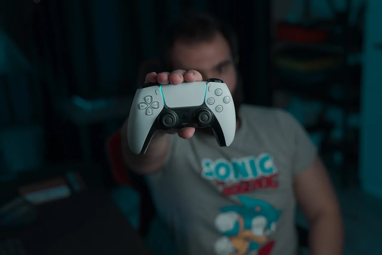 Gamer setting up a PS5 console at night before a game launch